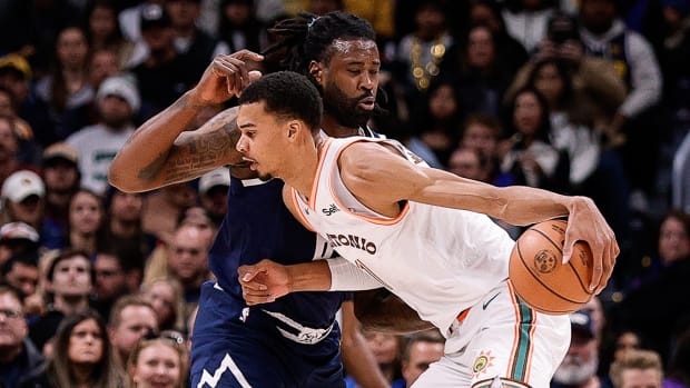 Spurs’ Victor Wembanyama backs down Nuggets’ DeAndre Jordan.